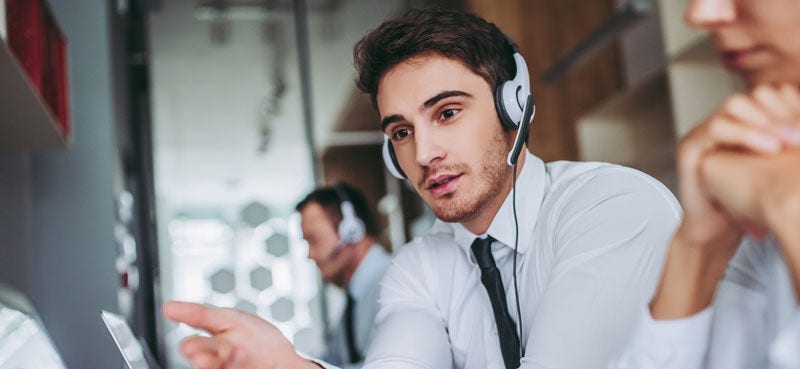 Man talking to customer on a phone headset