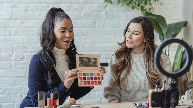 two women showing cosmetics