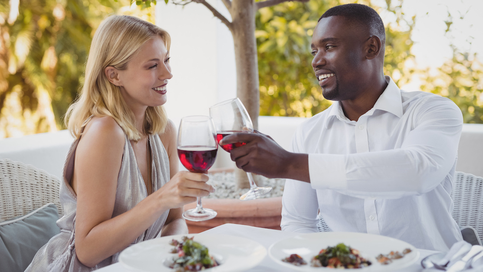 Romantic couple toasting their wine glasses in restaurant