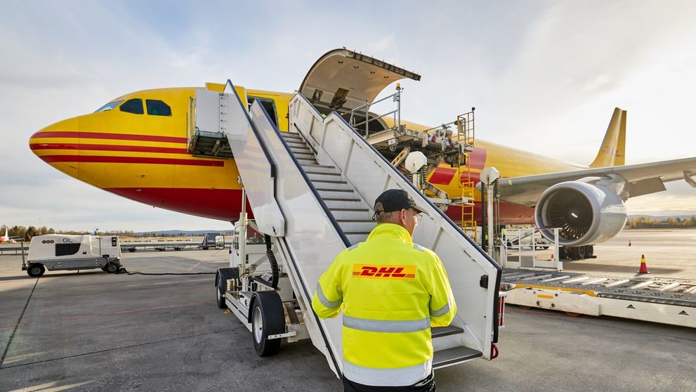 dhl staff loading cargo for an international shipment