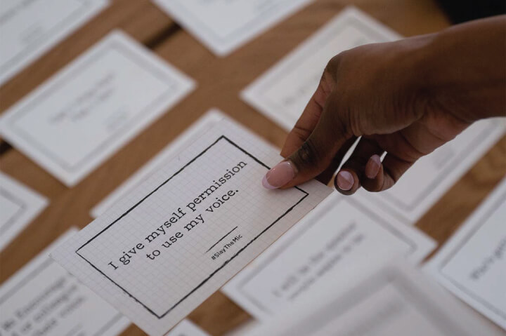 Jam holding a motivational speaking card