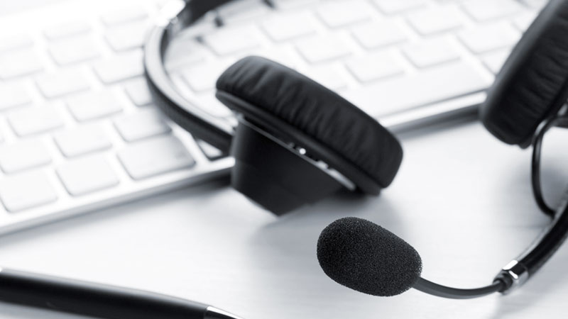 Phone headset resting on a keyboard