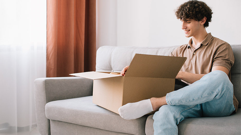 man looking into brown box