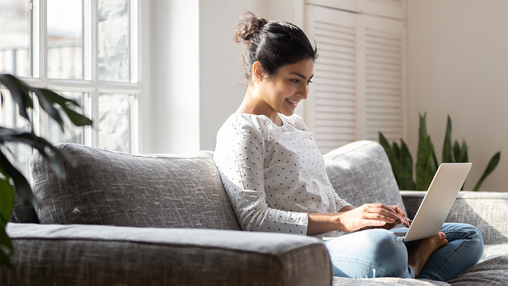 woman smiling at laptop screen