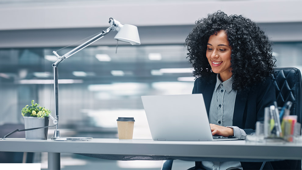 woman smiling at laptop screen