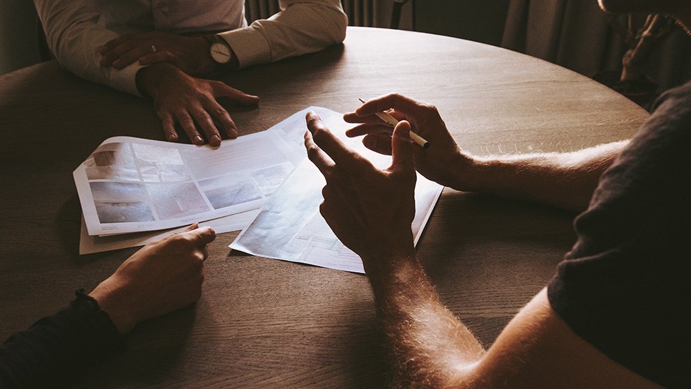 three pairs of hands on a table