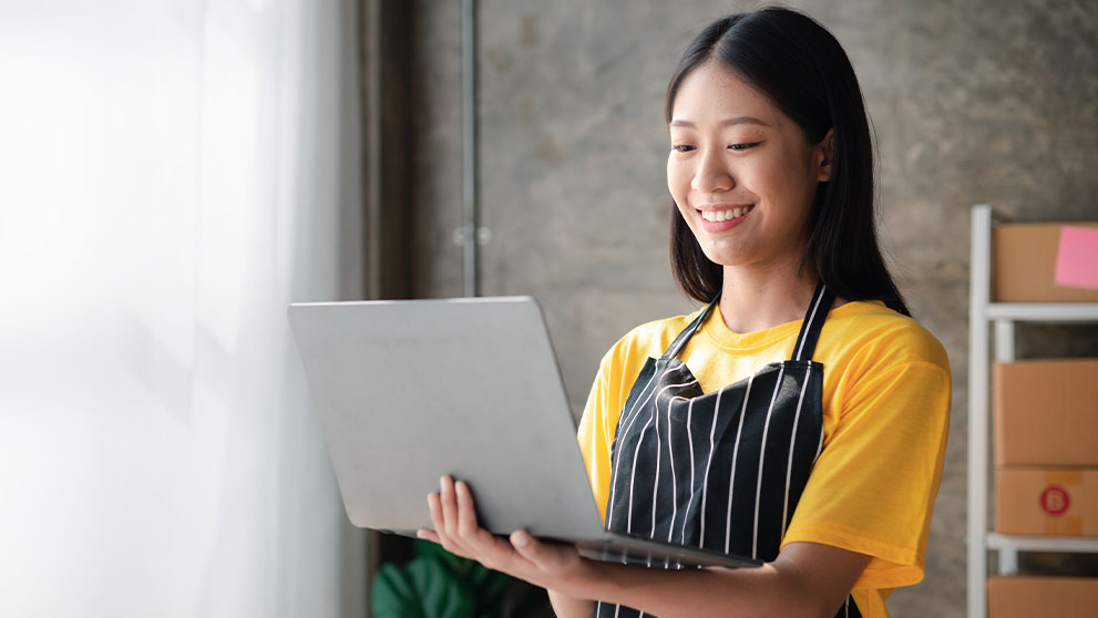 woman smiling at laptop screen