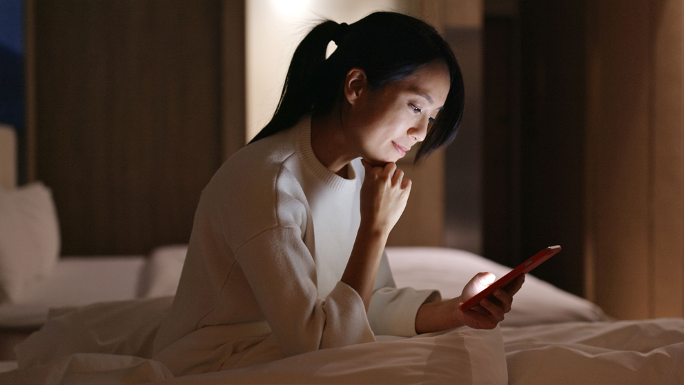 woman smiling at mobile phone