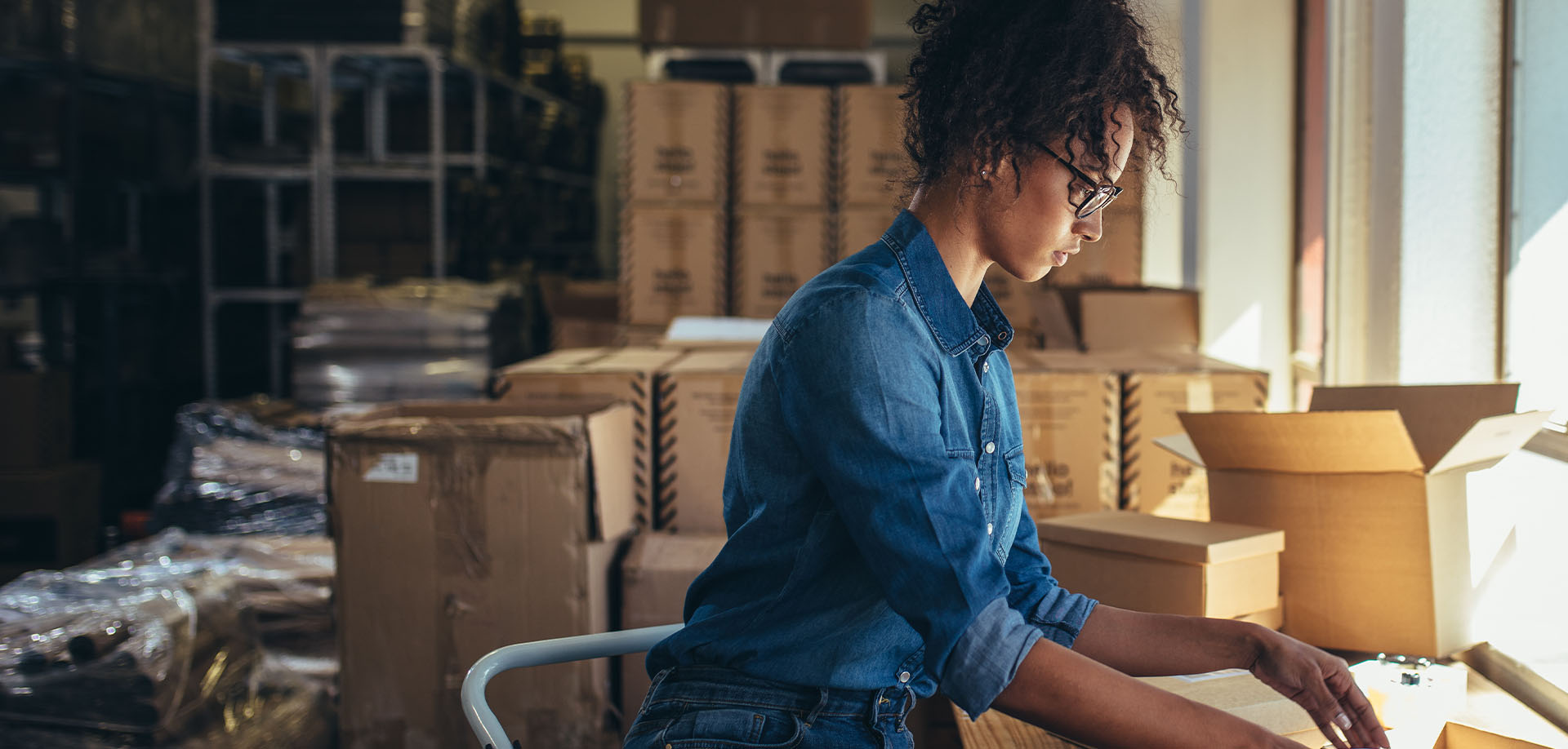 woman labelling parcels in storage room