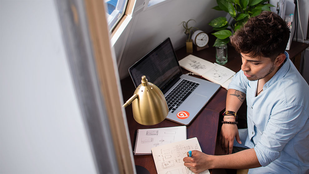 man writing at a desk