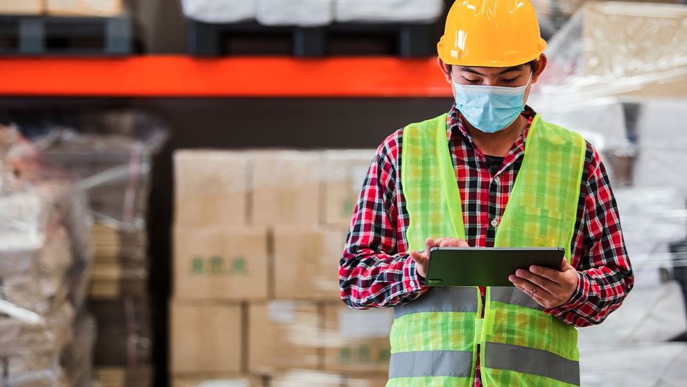 warehouse worker looking at a tablet