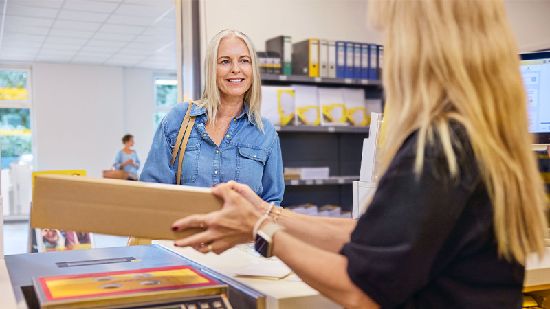 A customer is dropping a parcel off at a DHL Service Point