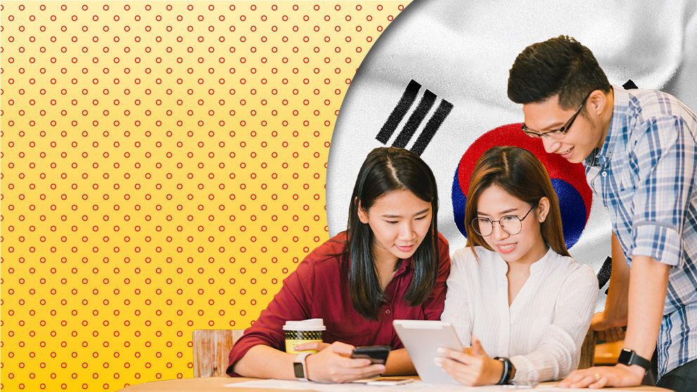 three people looking at tablet screen