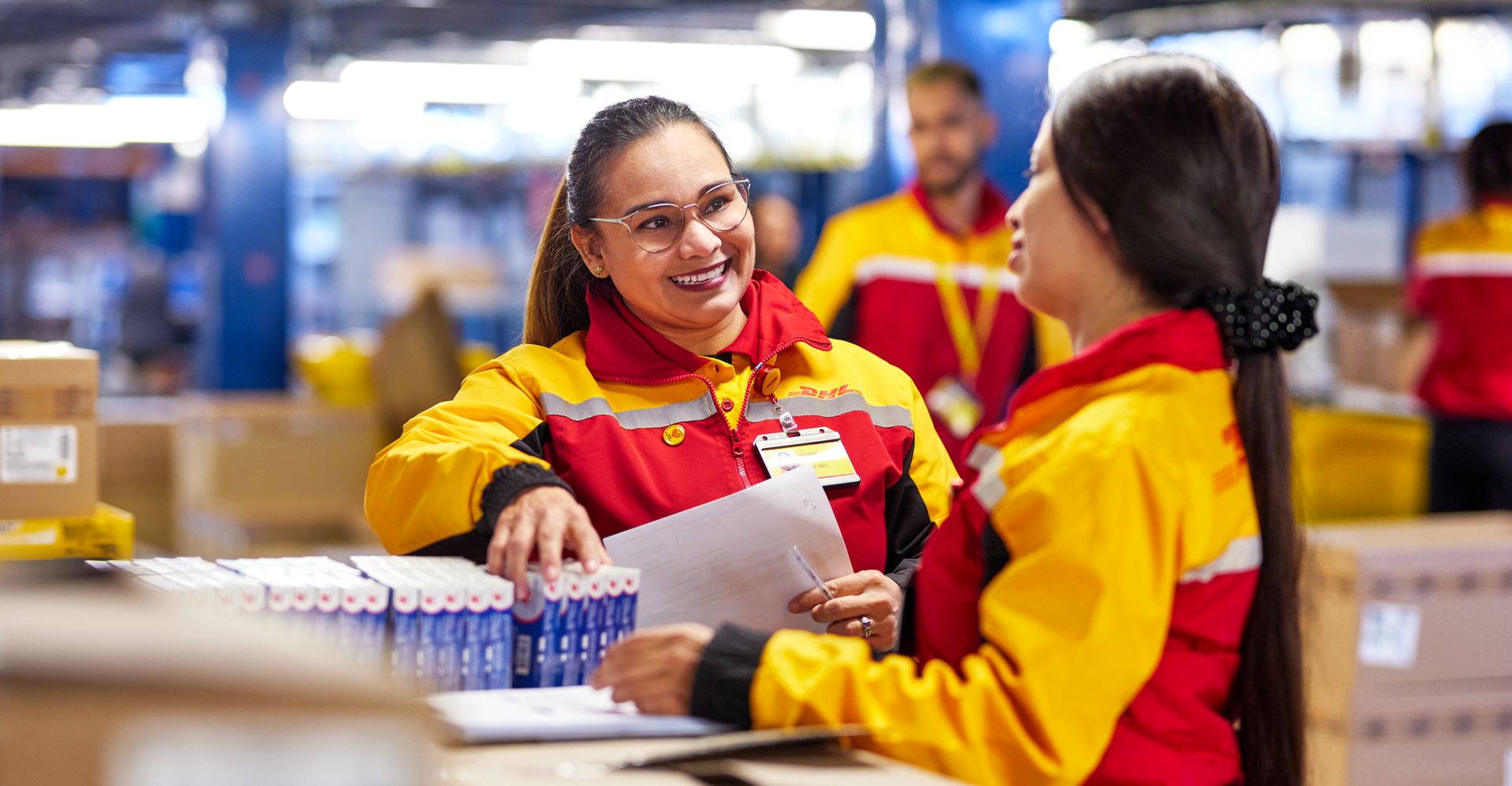 Karyawan DHL Express memeriksa barang dalam persiapan pengiriman internasional