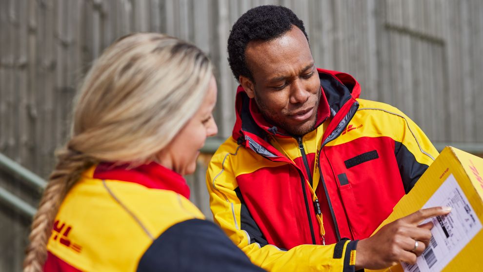 dhl express employee reading address on packing list or air waybill on shipment imported from myanmar