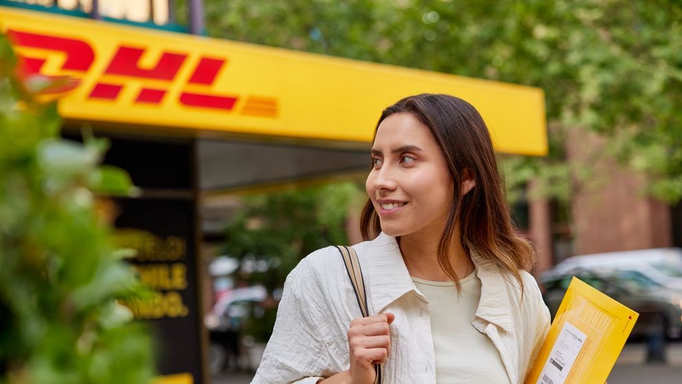 lady walking to dhl express to send documents overseas