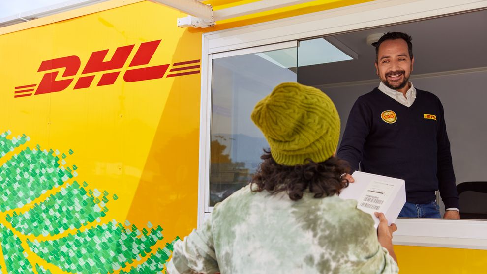 customer drops off parcel at dhl express service point following reverse logistics process