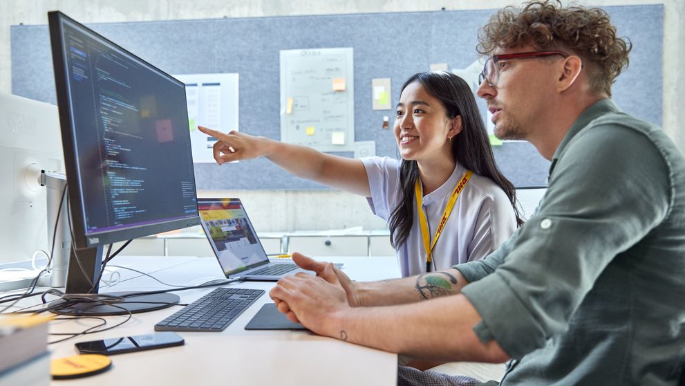 dhl express employee guiding her colleague on searchandising strategies