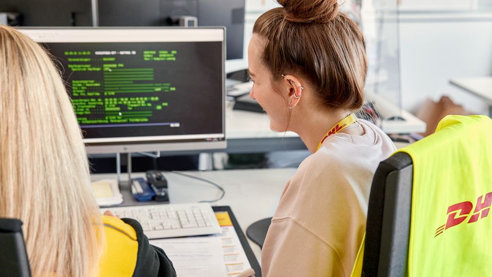 dhl staff looking at their monitor