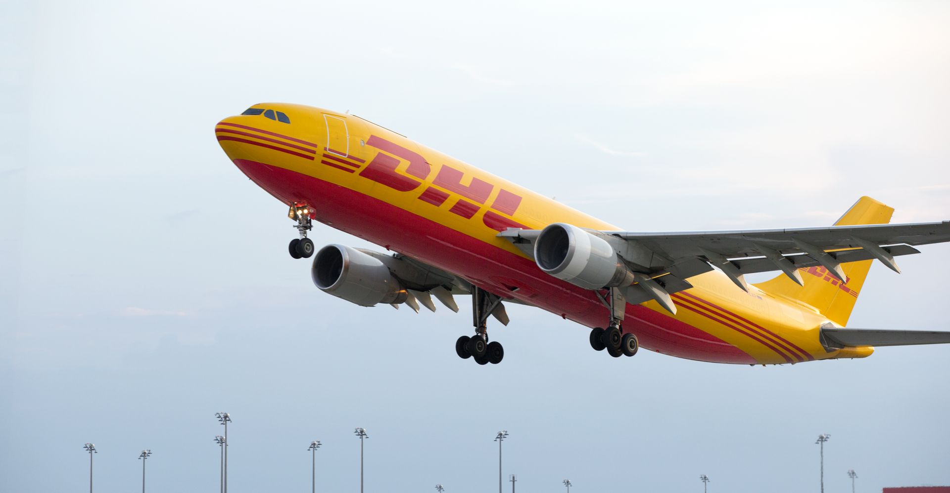 DHL freight plane taking off for international shipping