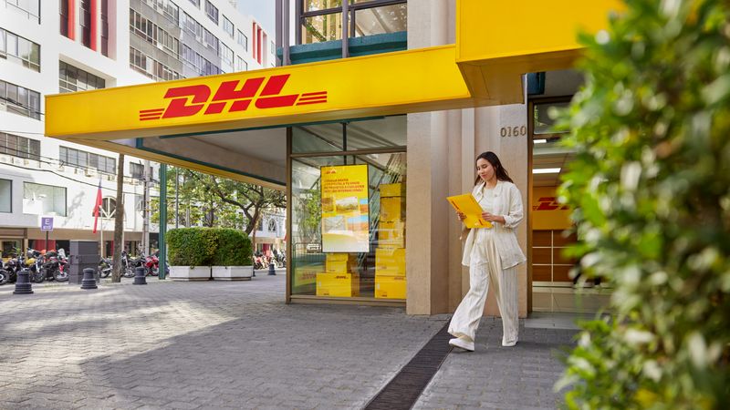 dhl express courier holding a package for international e-commerce shipping