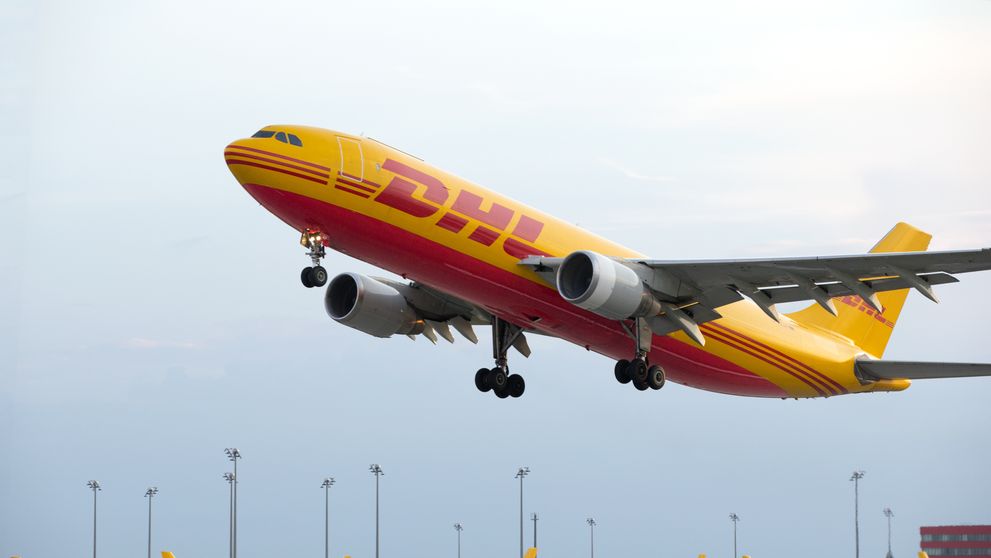 DHL freight plane taking off for international shipping