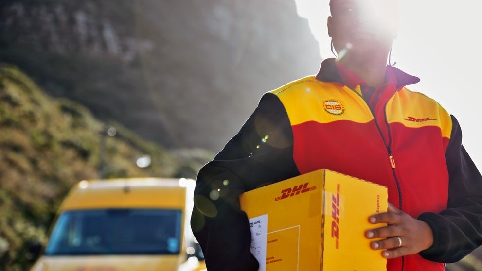 dhl express employee holding a parcel